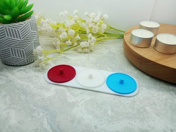 This version of the toothbrush holder is shown with the green, blue and white versions of the toothbrush holders attached to the white base. Each 3d printed holder has a small lip around the edge to help prevent drips. Three person electric toothbrush holders. Available in different colours. Choose from green, blue, yellow, red and white. Displaying yellow, blue and white.
