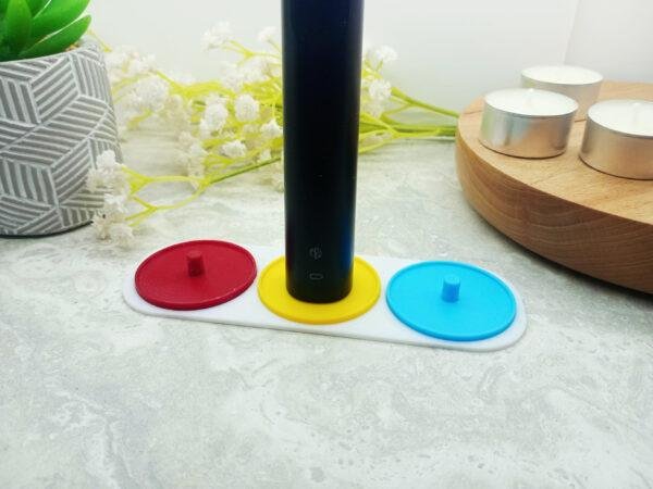 A three person Philips Sonicare electric toothbrush holder