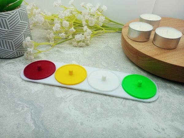 A 4 person toothbrush holder in red, yellow, green and white.