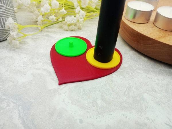 The yellow and blue toothbrush holder inserts are visible along with the small lip to reduce spillage onto the red heart section. A romantic heart shaped toothbrush holder suitable for Philips toothbrushes with yellow and blue toothbrush stands.